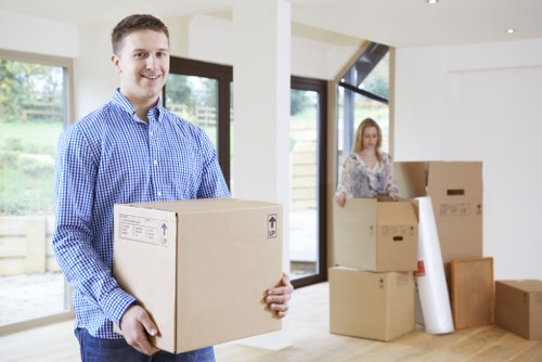 Local movers packing fragile household items in Welling