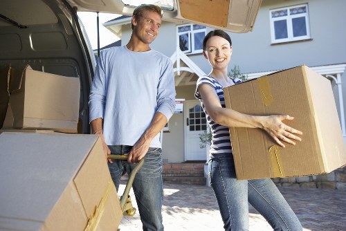 Local moving team handling boxes and furniture